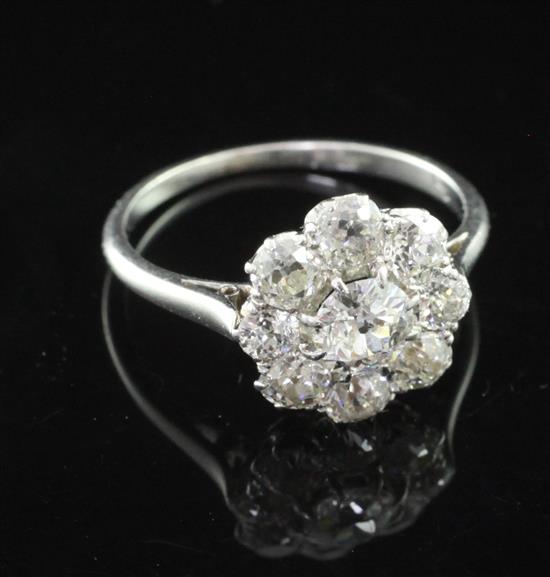 A mid 20th century platinum and diamond cluster ring, size K.